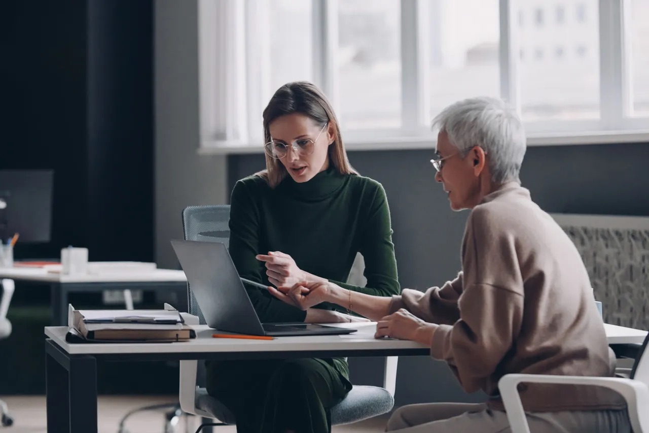 An adviser talking through options with a client at a desk